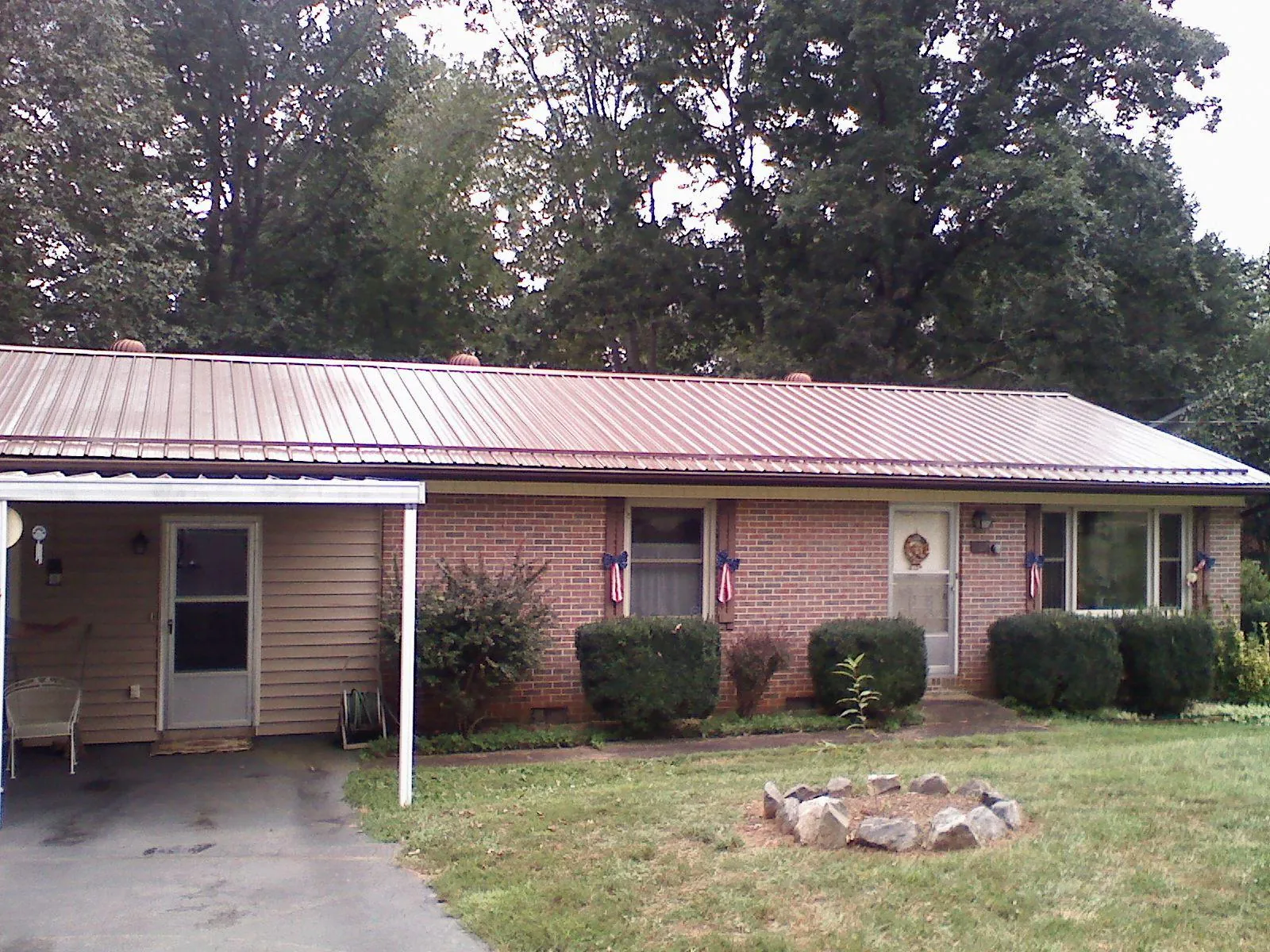 Bronze metal roof and carport on a brick ranch home — Roof Repair work by our crew in Shenandoah